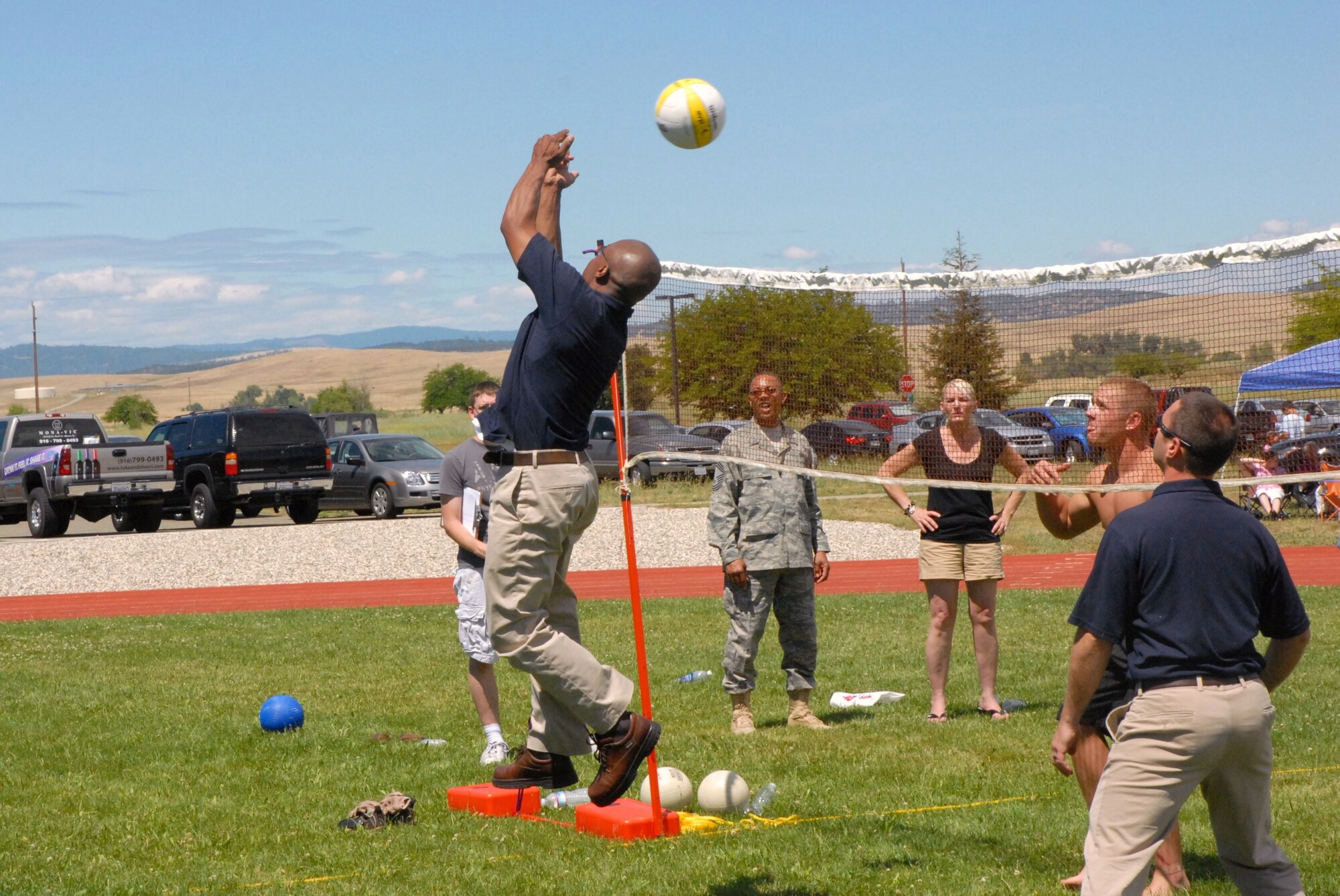 Tech Sgt. Johnson delivers a reverse two handed spike to the opposition during the volleyball tournament. (U.S. Air Force Photo/A1C Adam Hamar)