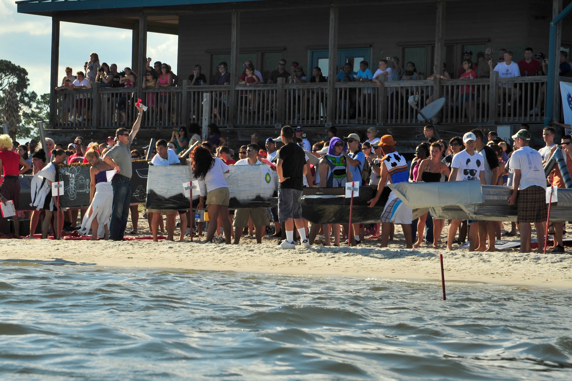 U.S. Air Force Col. Michael Plehn, 1st Special Operations Wing commander, sounds the horn to kick off the 22nd Annual Cardboard Boat Regatta race at Hurlburt Field, Fla., July 2, 2010. (DoD photo by Senior Airman Sheila deVera/RELEASED)