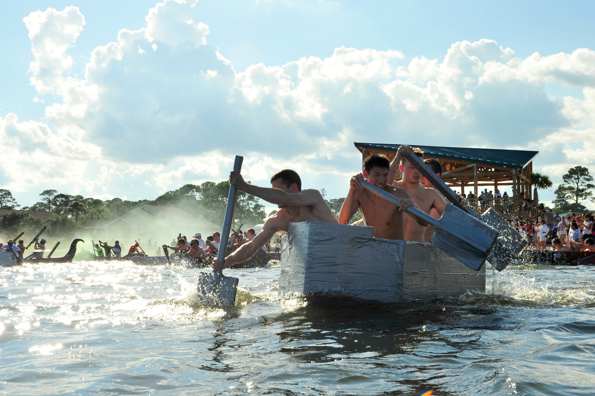 Bomb Cat crew members from the 413th Flight Test Squadron paddle through the marina during the 22nd Annual Cardboard Boat Regatta at Hurlburt Field, Fla., July 2, 2010. The Bomb Cat took second place in the fastest boat category. (DoD photo by Senior Airman Sheila deVera/RELEASED)