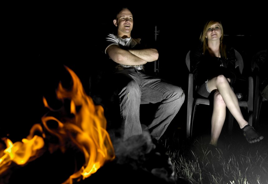 MINOT, N.D. -- Airman 1st Class Nicholas Clum, 5th Operations Support Squadron aviation resource management, and Airman 1st Class Kara Kwiatkowski, 5th Logistics Readiness Squadron receiving journeyman, watch fireworks at a friend’s house while enjoying a campfire here July 4. Minot’s Airmen and their families enjoyed fun, festivities and fireworks both on- and off-base during the 2010 celebration of our nation’s independence. (U.S. Air Force photo by Senior Airman Benjamin Stratton)