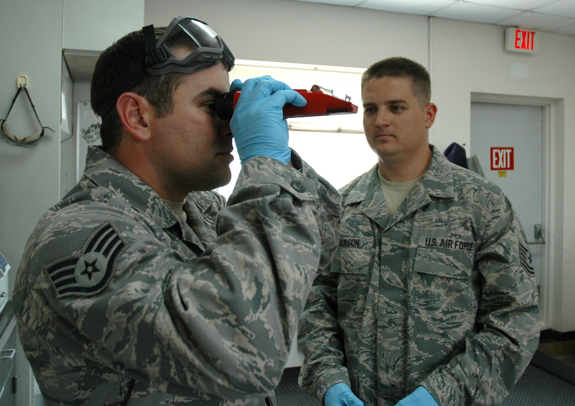 DOVER AIR FORCE BASE, Del.- Tech. Sgt. David Jackson (right), 512th Logistics Readiness Flight Fuels shop NCO in-charge here, monitors his troop Staff Sgt. James Steinbrueck, 512th LRF Fuels training monitor, as he measures the concentration of a fuel sample with a B2 refractometer. Sergeant Jackson was nominated as Air Force Reserve Command's representative for the 2010 Airlift Tanker Association Young Leadership Award representing the NCO catagory in June. He will compete for the award at the Air Mobility Command level in October. (U.S. Air Force photo/Master Sgt. Jake Chappelle)
