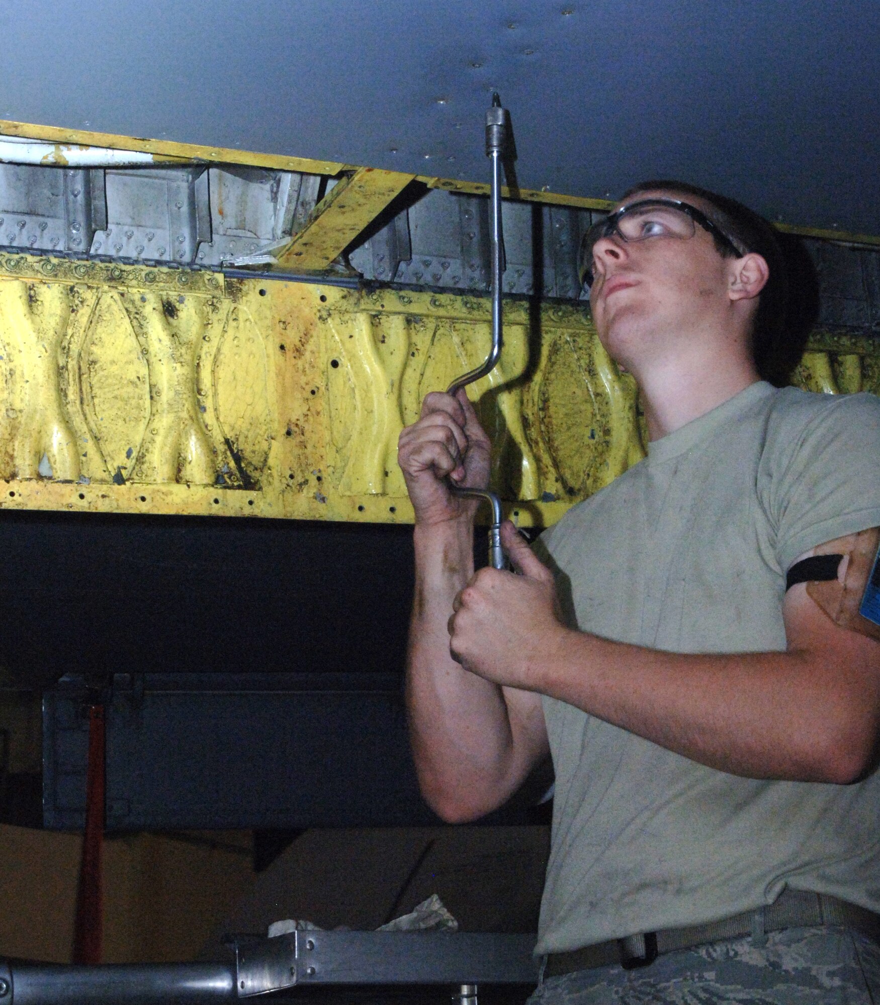 Airman 1st Class Ryan Hubbard, 319th Aircraft Maintenance Squadron, removes screws from the balance bay panel on the right wing of a KC-135 Stratotanker during periodic inspection July 6. The inspection is the last one the wing will perform on its tankers at Grand Forks Air Force Base as the wing continues its transition from KC-135 Stratotanker to unmanned aerial systems. (U.S. Air Force photo by Airman 1st Class Rachel Martinez)