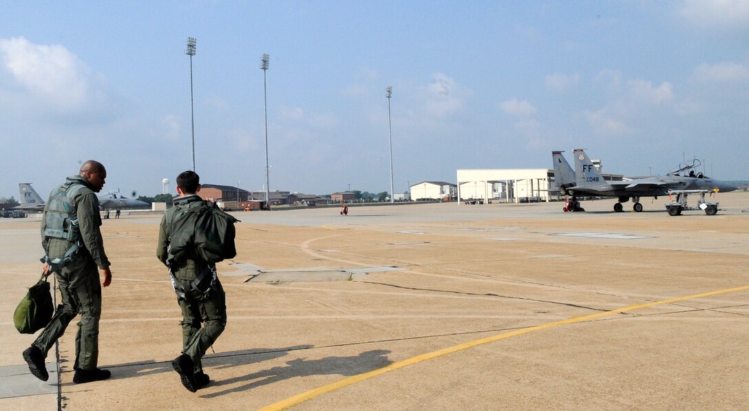 LANGLEY AIR FORCE BASE, Va. – U.S. Air Force Capt. Justin Eagan, 71st Fighter Squadron pilot, escorts U.S. Army Col. Reggie Austin, 633d Air Base Wing vice commander, to their jet for an F-15C Eagle incentive flight July 6.  Colonel Austin took the opportunity to familiarize himself with the aircraft and it’s unique capabilities as the Air Force and Army join forces under Joint Base Langley-Eustis.  (U.S. Air Force photo/ Senior Airman Dana Hill)

