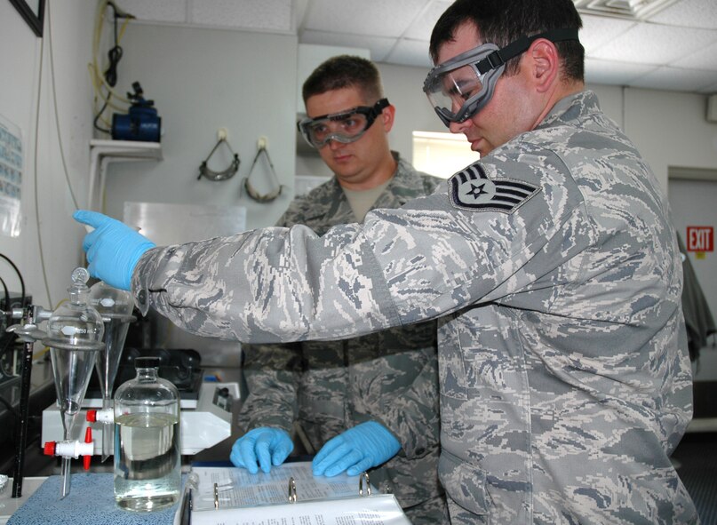 DOVER AIR FORCE BASE, Del.- Tech. Sgt. David Jackson (left), an air reserve technician with the 512th Logistics Readiness Flight here, trains his troop Staff Sgt. James Steinbrueck, 512th LRF Fuels training monitor, on the proper testing procedures for a fuel system icing inhibitor analysis, which lowers the freezing point of small quantities of free water in fuel. Sergeant Jackson was nominated as Air Force Reserve Command's representative for the 2010 Airlift Tanker Association Young Leadership Award for the NCO catagory in June. He will compete for the award at the Air Force level in October. (U.S. Air Force photo/Master Sgt. Jake Chappelle) 
