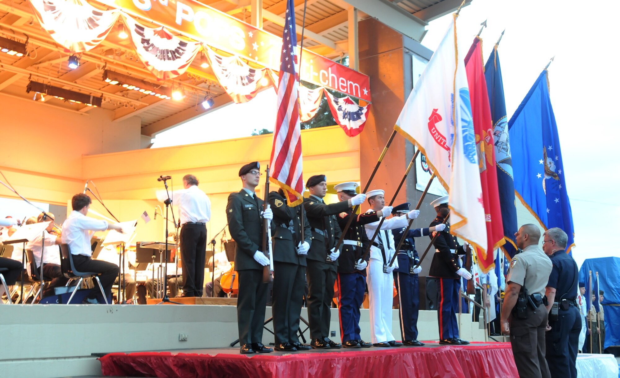 The Goodfellow Joint Service Color Guard presents the Colors during the 23rd Annual July 3rd Pops Concert at the San Angelo River Stage. Members from the 17th Training Group also participated in this year's event by marching in formation bearing each of the 50 state flags, honoring our past and present military members. Col. Thomas Geary, 17th Training Wing commander, also provided opening remarks during the event. (U.S. Air Force photo/Airman 1st Class Clayton Lenhardt)