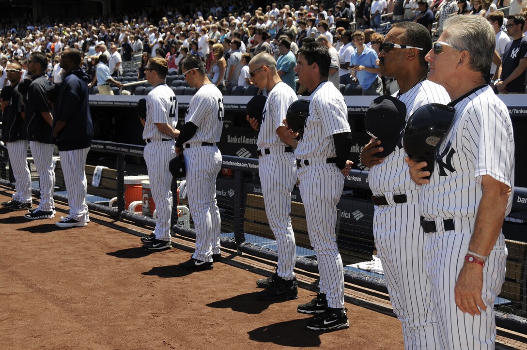 New York Yankees members place their hats over their hearts as the U.S. Air Force Band Ceremonial Brass performs July 2 at Yankee Stadium in New York City. The Ceremonial Brass performed the American and Canadian national anthems in honor of the Yankees going up against the Toronto Blue Jays. (U.S. Air Force photo by Airman 1st Class Susan Moreno)