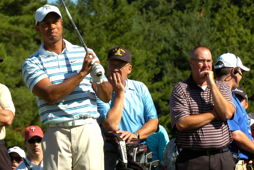 Retired Pennsylvania Army National Guard Col. Joe Laneski and Chief Master Sgt. George Vasiloff, far right, study the swing and strategy of 14-time major golf champion Tiger Woods. 