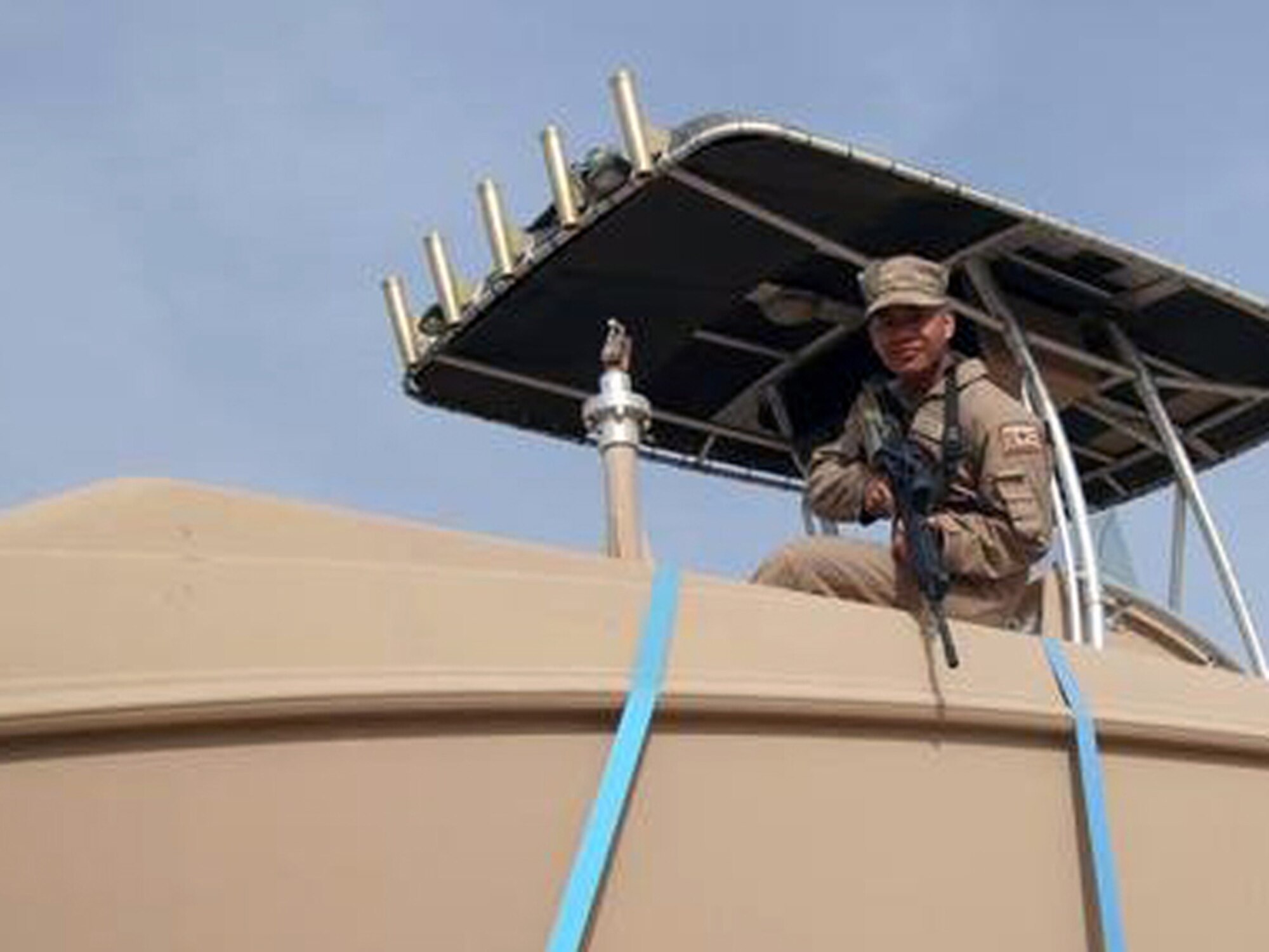 CAMP ARFIJAN, Kuwait – Senior Airman Joseph Adams, 424th Medium Truck Detachment, uploads and ties down a boat on to a trailer as he prepares to depart for a convoy mission.  Airman Adams is deployed to Camp Arfijan, Kuwait, from the 509th Logistics Readiness Squadron as a truck commander.   
