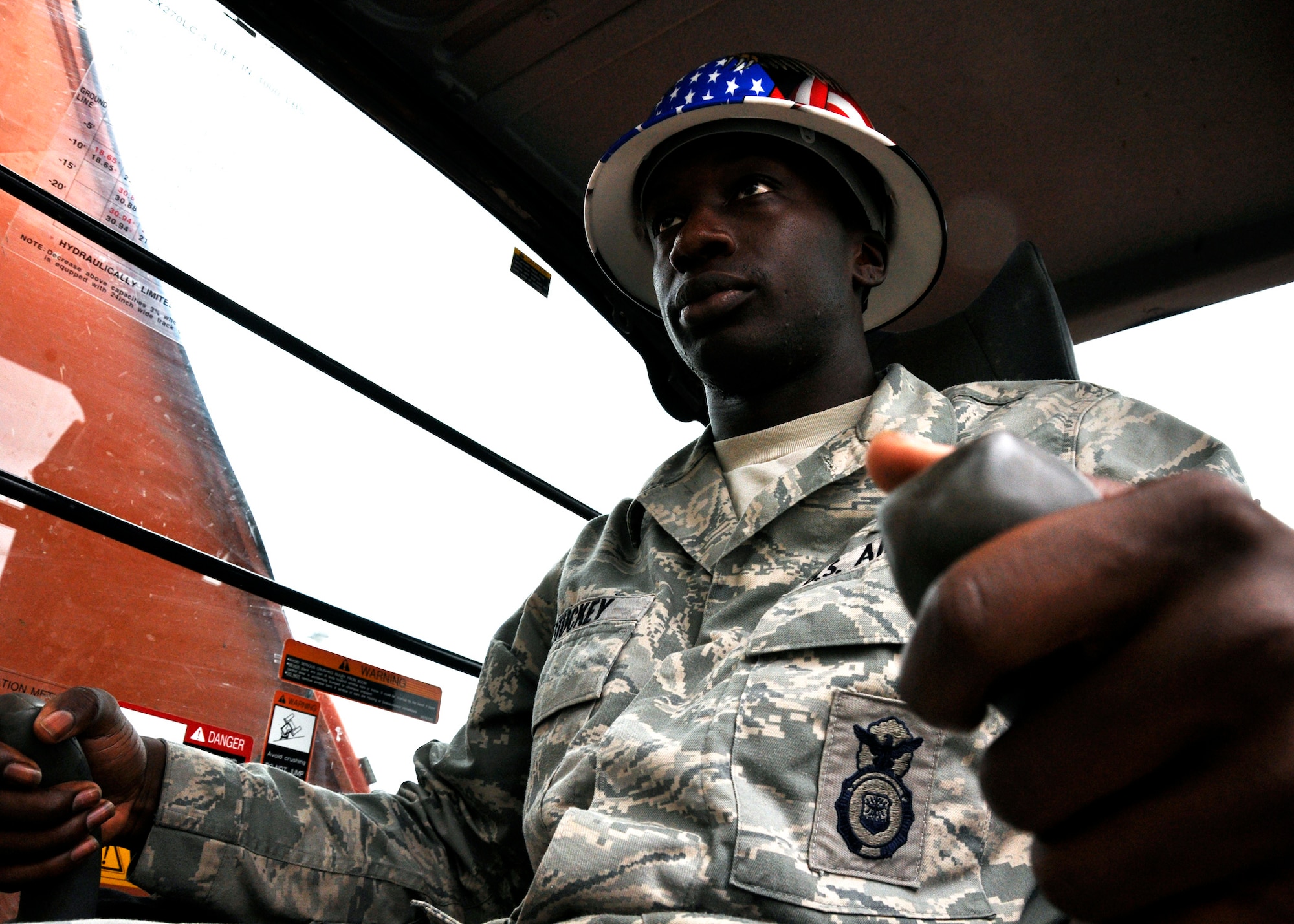 Senior Airman Isaac Stuckey, 96th Security Forces Squadron,  waits to begin the demolition of Dorm 17, the last of the old dorms along Eglin Boulevard, July 6.  Airman Stuckey spent eight months in the “old” dorms before deploying.  He also lived in the new quad-style dorms as well and said they were “much better.”  According to 96th Civil Engineer Group, the dorm will be completely leveled and cleaned up in eight weeks.  All of the concrete within the structure will be recycled.  (U.S. Air Force photo/Samuel King Jr.)