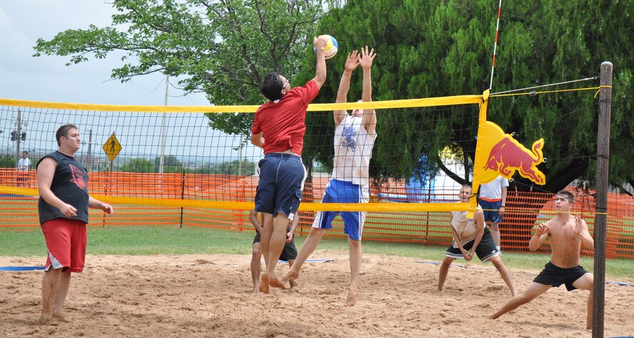 Brandon Crawford's team (left), from downtown Wichita Falls, and Kevin Taylor's team (right), from the 364th Training Squadron, compete in the finals for the championship trophy at the Sheppard Freedom Fest 2010 Four-Person Volleyball Tournament at Sheppard Air Force Base, Texas, July 3, 2010. After about four hours of elimination rounds, Crawford's team won the tournament with the following scores: 15-8, 11-15, 15-13. Five teams from Wichita Falls, Texas, and seven teams from Sheppard competed in games lasting about 20-25 minutes. The team winning the best two-out-of-three minigames advanced to the next level of the tournament. (U.S. Air Force photo/Airman 1st Class Valerie Hosea)