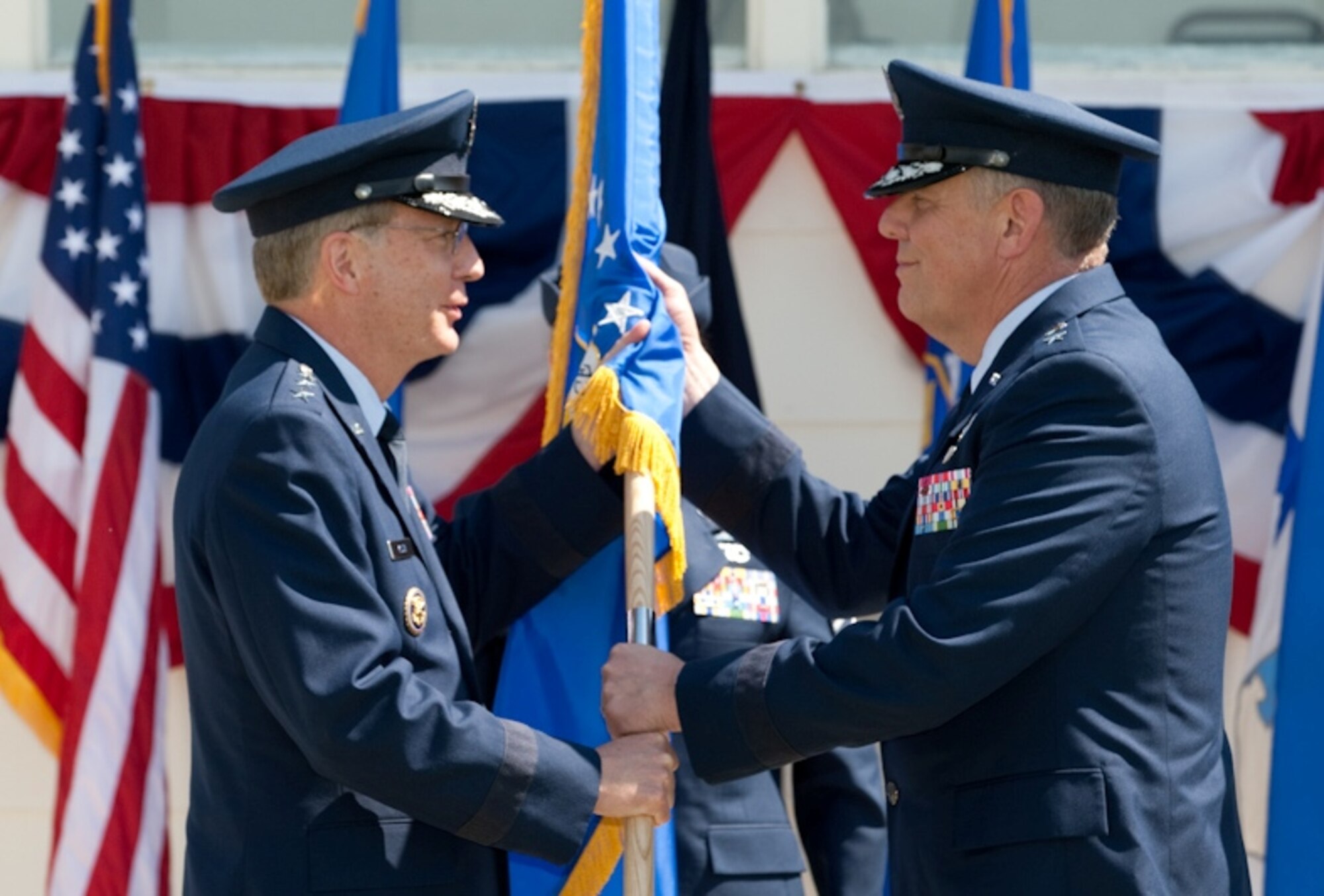 F.E. WARREN AIR FORCE BASE, Wyo. - Lt. Gen. Frank Klotz, Air Force Global
Strike Command commander, passes the Twentieth Air Force flag to Maj. Gen.
C. Donald Alston during a change of command ceremony here at the Argonne
Parade Field July 1. General Alston assumed the command of Twentieth Air
Force after an assignment as the Assistant Air Force Chief of Staff for
Strategic Deterrence and Nuclear Integration at the Pentagon (U.S. Air Force
photo/Jeff Allred).