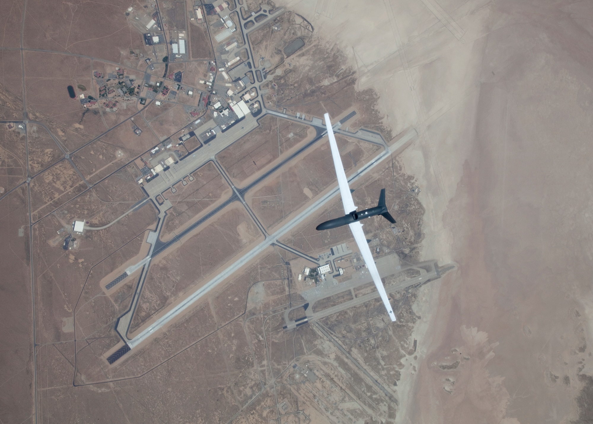 The Euro Hawk flies high above Edwards Air Force Base June 29.  The unmanned aircraft system, built by Northrop Grumman and European Aeronautic Defence and Space, completed its first flight after taking off from Northrop's Palmdale, Calif., manufacturing facility and then landing at Edwards.  The Euro Hawk has a wingspan larger than a commercial airliner and can fly for more than 30 hours at high altitudes.  (Air Force photo by Bobbi Zapka)