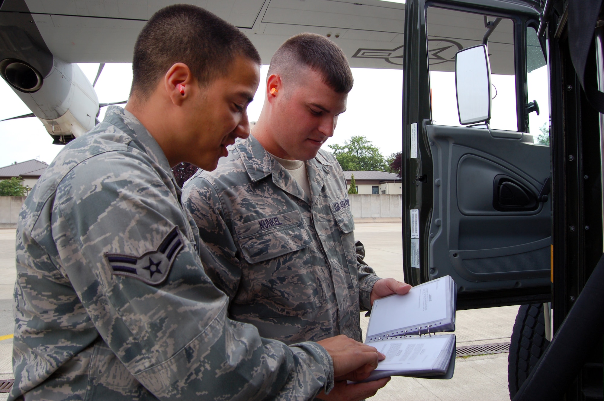 WRIGHT-PATTERSON AIR FORCE BASE, Ohio – Senior Airman Jonathon Kunkel, 445th Logistics Readiness Squadron, fuels management flight, trains alongside Airman First Class Adrian Leyba, 86th Logistics Readiness Squadron, at Ramstein Air Base, Germany, June 9. More than 40 members of the 445 LRS spent their annual tour in Germany June 5-19. (U.S. Air Force photo/Maj. Jose Cardenas)