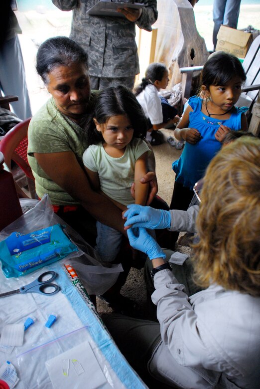 LOS PLANES, Honduras --  Dr. Teri Kemmer, an assistant professor of nutrition at South Dakota State University, prepares to take a blood sample from a local child during a medical readiness training exercise here June 28. Doctor Kemmer, who is a retired U.S. Army dietician officer, started the joint program in 2001 in order to both assist the Honduran Ministry of Health with the assessment of nutrition in rural areas and train military pediatricians. (U.S. Air Force photo/Tech. Sgt. Benjamin Rojek)