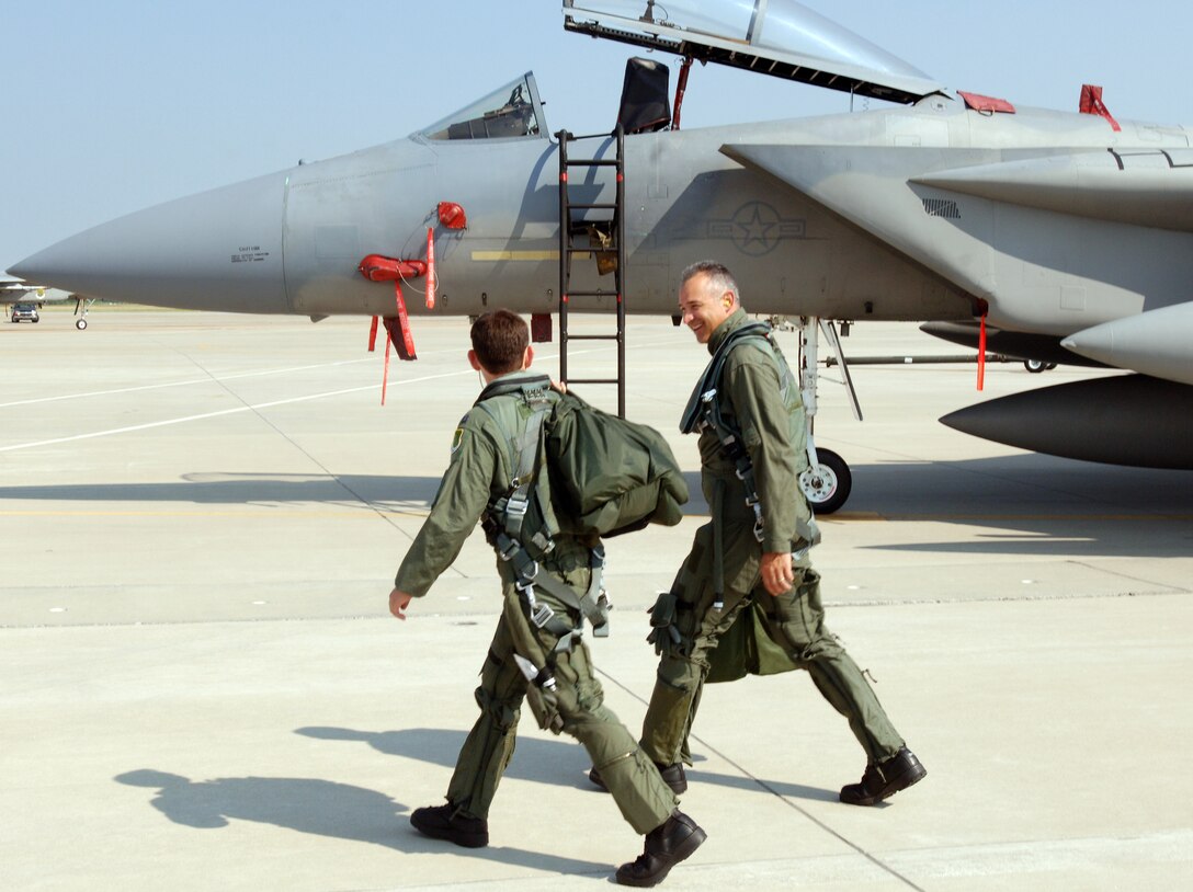 LANGLEY AIR FORCE BASE, Va.  -- U.S. Air Force Capt. Justin Eagan, 71st Fighter Squadron pilot, escorts U.S. Army Col. Glenn Grothe, 733rd Mission Support Group Commander, to their jet for an F-15C Eagle incentive flight July 6. Colonel Grothe took the opportunity to familiarize himself with the aircraft and it’s unique capabilities as the Air Force and Army join forces under Joint Base Langley-Eustis.  (U.S. Air Force photo/Senior Airman Jarrod Chavana)