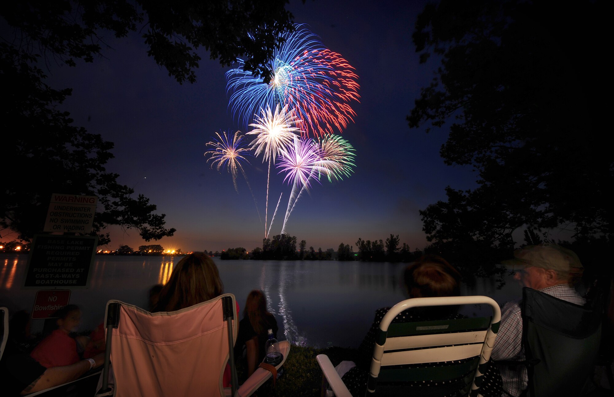 OFFUTT AIR FORCE BASE, Neb. - Bursts of red, white and blue fill the night sky July 2 at Offutt's base lake during the annual fireworks display.  Several family activities took place at the celebration including appearances by a professional magician and a small play given by Prairied Treasure Melodrama. U.S. Air Force photo by Josh Plueger
