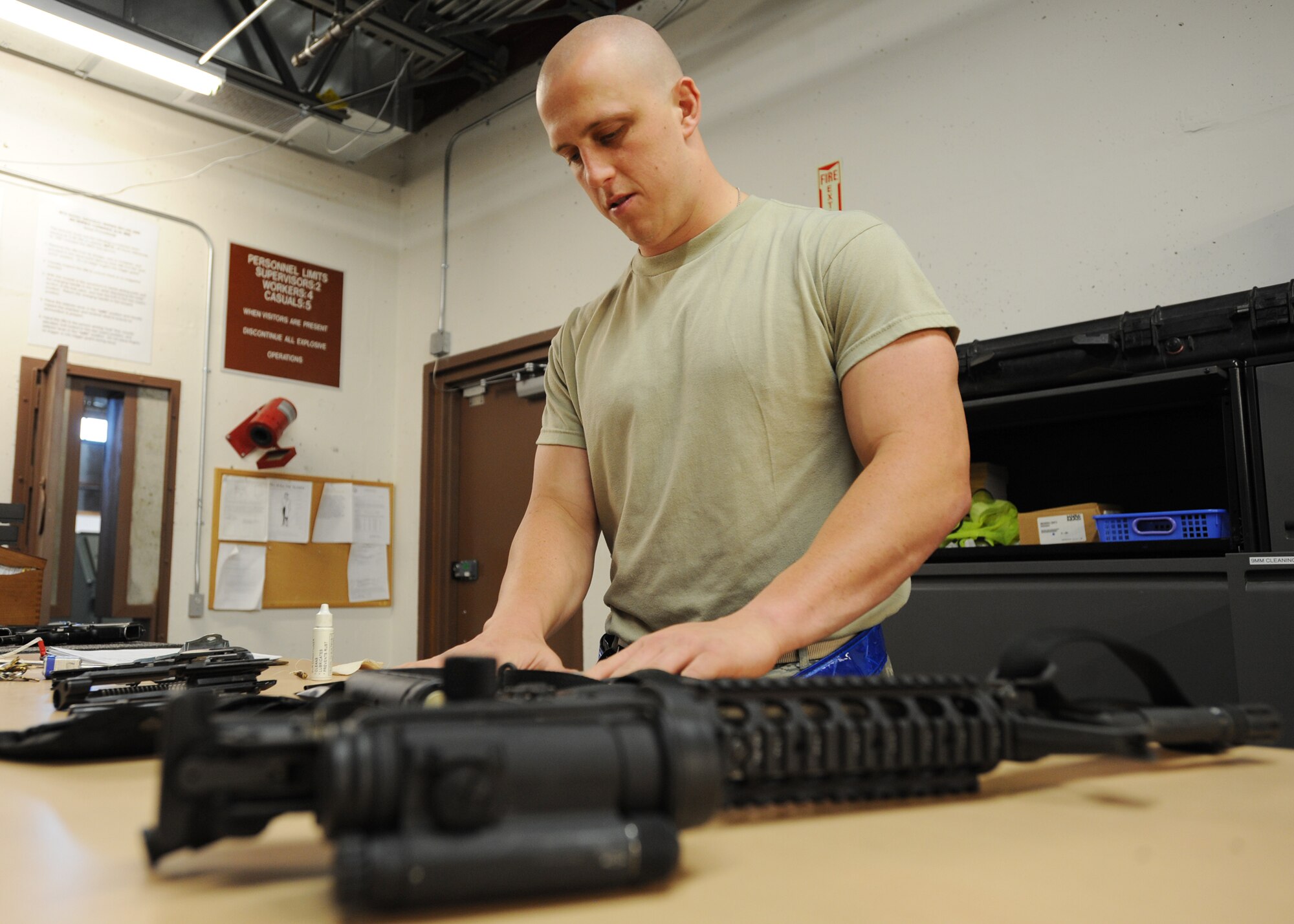 Airman 1st Class Dusty Parsons, 22nd Logistics Readiness Squadron weapons vault specialist, prepares an M-4 rifle for personnel during an exercise June 24, 2010, McConnell Air Force Base, Kan.   Weapons are cleaned and inspected before being issued to Airmen deploying or participating in exercises.  The 22nd Logistics Readiness Squadron maintains and provides equipment to McConnell Airmen for use during training exercises and real-world deployments.  (U.S. Air Force photo/Airman 1st Class Andrea Salazar)