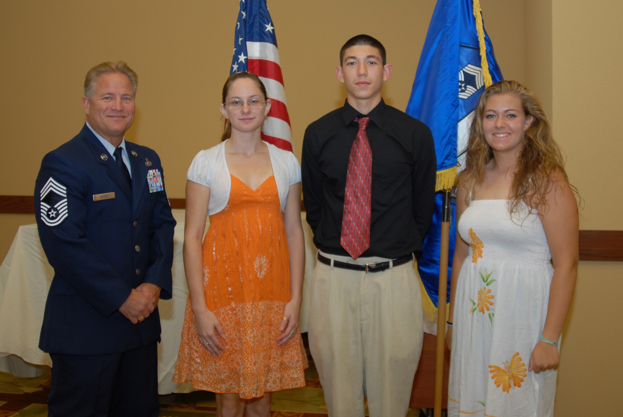 Chief Master Sgt. Eicher poses with from left, Elizabeth Drewry, Roman Chai, and Jasmine Jordan, winners of the Hurlburt Field's Chiefs Group Scholarship at the Soundside Club, Hurlburt Field, Fla., July 1, 2010.  (U. S. Air Force photo by Staff Sgt. Orly N. Tyrell/Released)