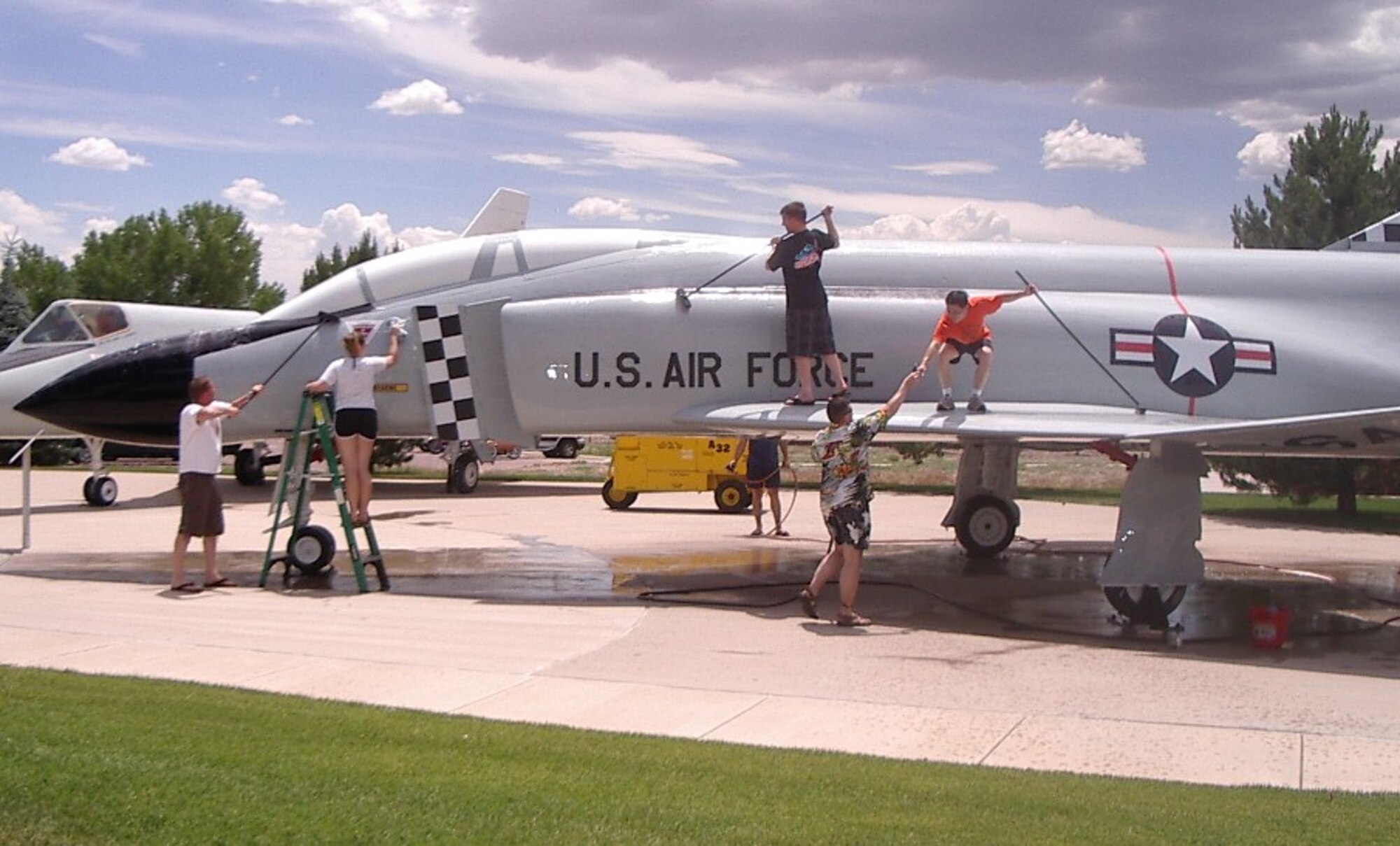 PETERSON AIR FORCE BASE, Colo. -- Airmen from Air Force Operational Test and Evaluation Center, Detachment 4, wash an F-4C "Phantom II" June 25 at the Peterson Air and Space Museum. The detachment joined the museum’s "Adopt-A-Plane" program, which provides periodic cleanings throughout the year. Units interested in participating in this volunteer program can contact Jeff Nash at 556-8314 for information. (U.S. Air Force photo/Jeff Nash)