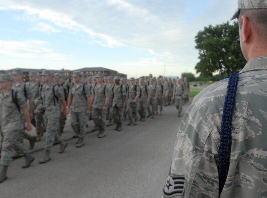 A Military Training Leader from the 316th Training Squadron keeps an eye on a formation of Airman as they march to class June 6. MTL’s insure that the lessons learned in Basic Military Training are reinforce as each new Airman progresses through their technical training and leave for their first assignment. (U.S. Air Force photo/Master Sgt. Randy Mallard)
