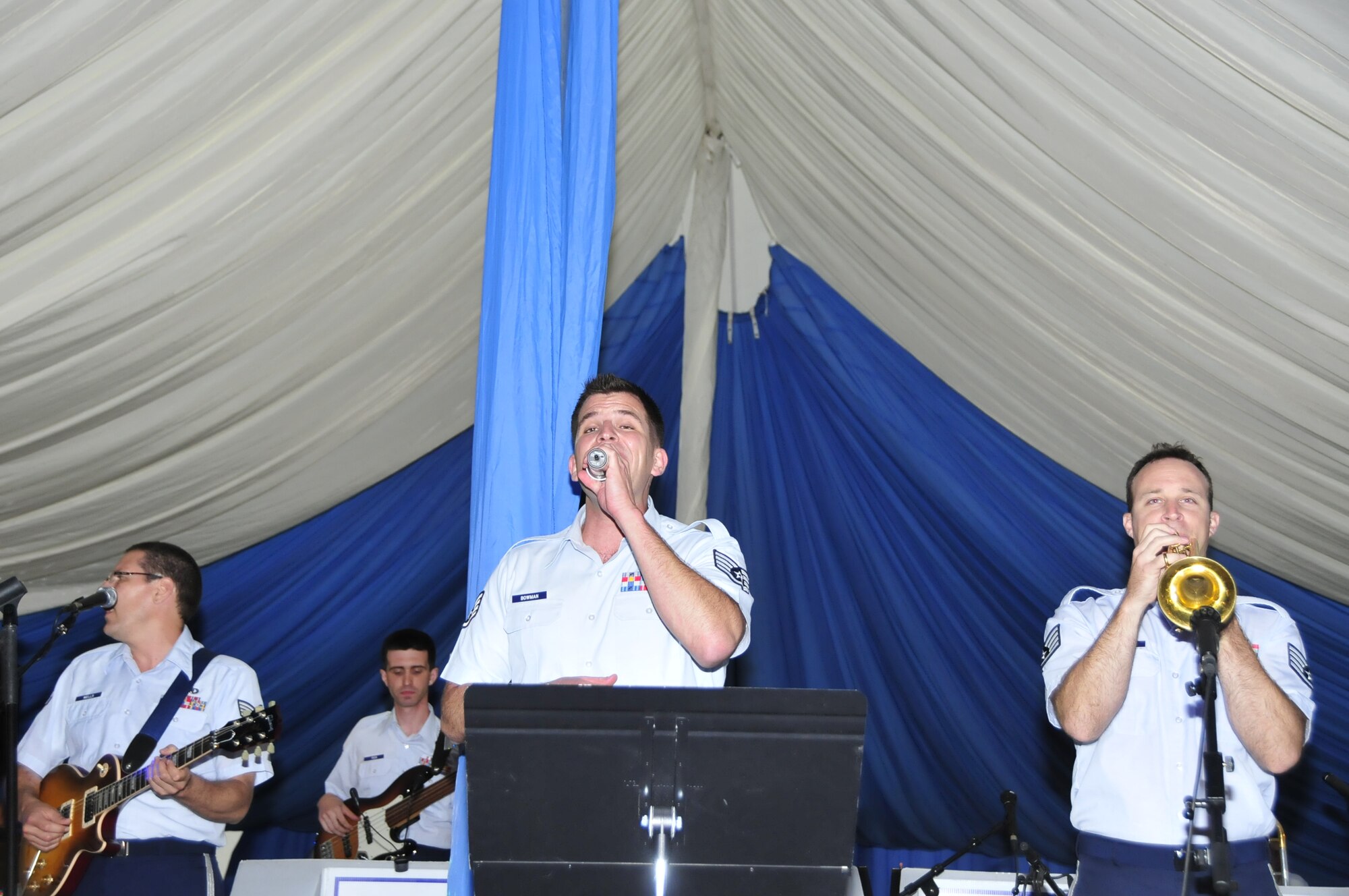 Members of the United States Air Forces in Europe band perform the Stevie Wonder hit “So what the fuss” for attendees to the Independence Day at RAF Feltwell July 4. The USAFE band performed a variety of songs throughout the night all the way up until the fireworks display. Left to right, Staff Sgt. Paul Wells, guitar, Staff Sgt. Craig Bowman, vocalist and Staff Sgt. Gene Dooley, trumpet. (U.S. Air Force photo/Airman 1st Class Eboni Knox)