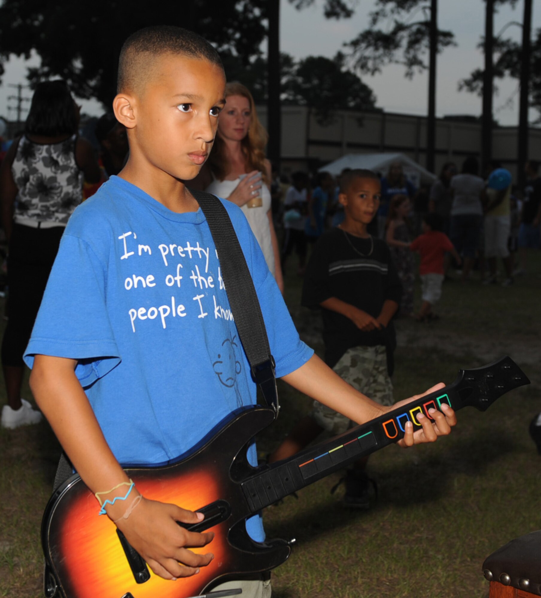 SEYMOUR JOHNSON AIR FORCE BASE, N.C. -- Aaron Macias plays Rock Band during the Fourth  of July celebration here July 1, 2010. The celebration festivities included games, a car show and a kid zone. Aaron is the son of Meylene Macias and is a native of Goldsboro. (U.S. Air Force photo/Senior Airman Gino Reyes)