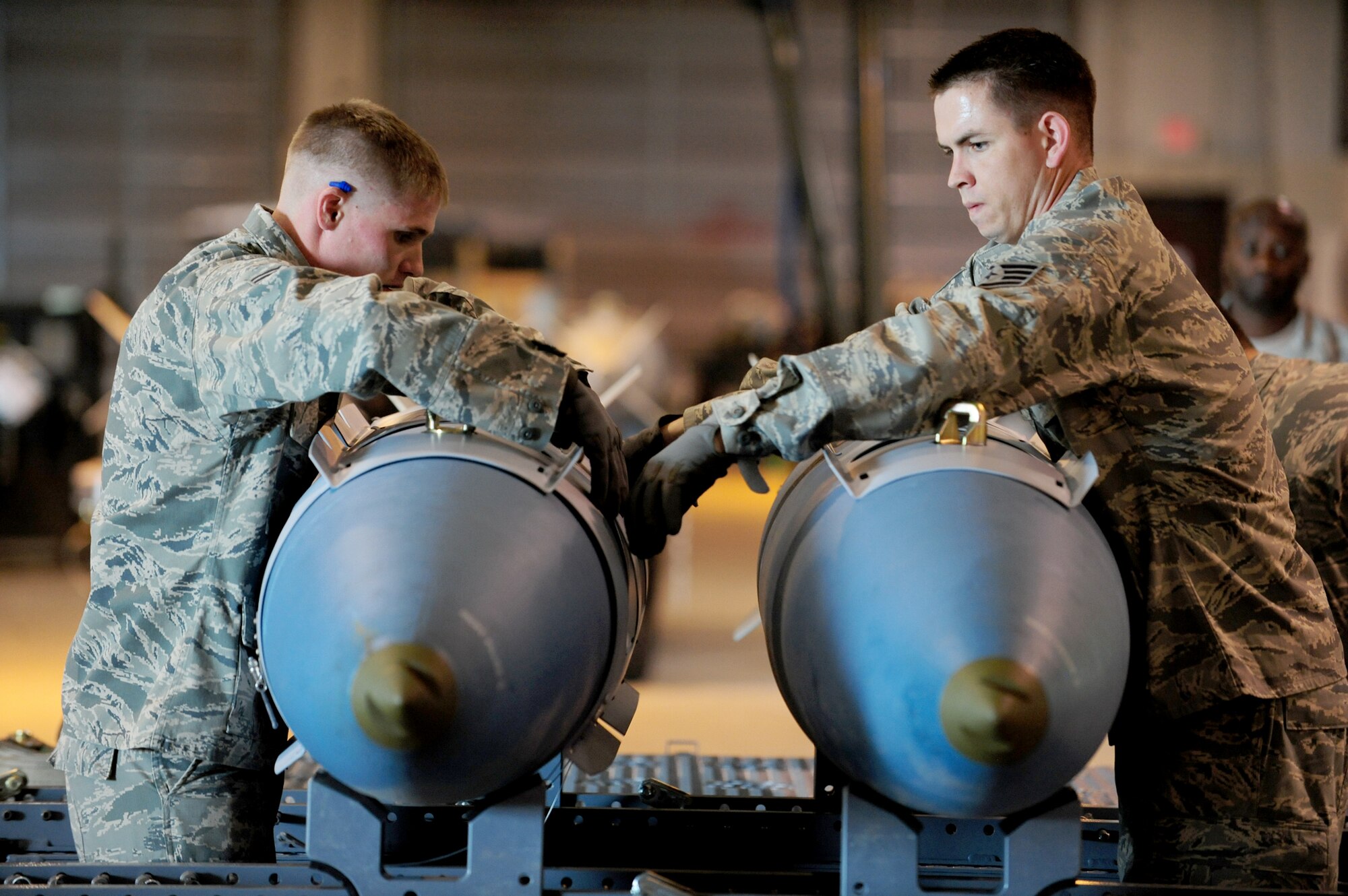 Senior Airman Joshua Price (Left) and Staff Sgt. Darrell Rinde help build two training bombs during Global Strike Challenge, June 9, 2010, at Ellsworth Air Force Base, S.D. The 28th Bomb Wing is one of seven bomb wings to participate in Air Force Global Strike Command's first load competition. Airman Price and Sergeant Rinde are 28th Munitions Squadron bomb build team members. (U.S. Air Force photo/Airman 1st Class Corey Hook)