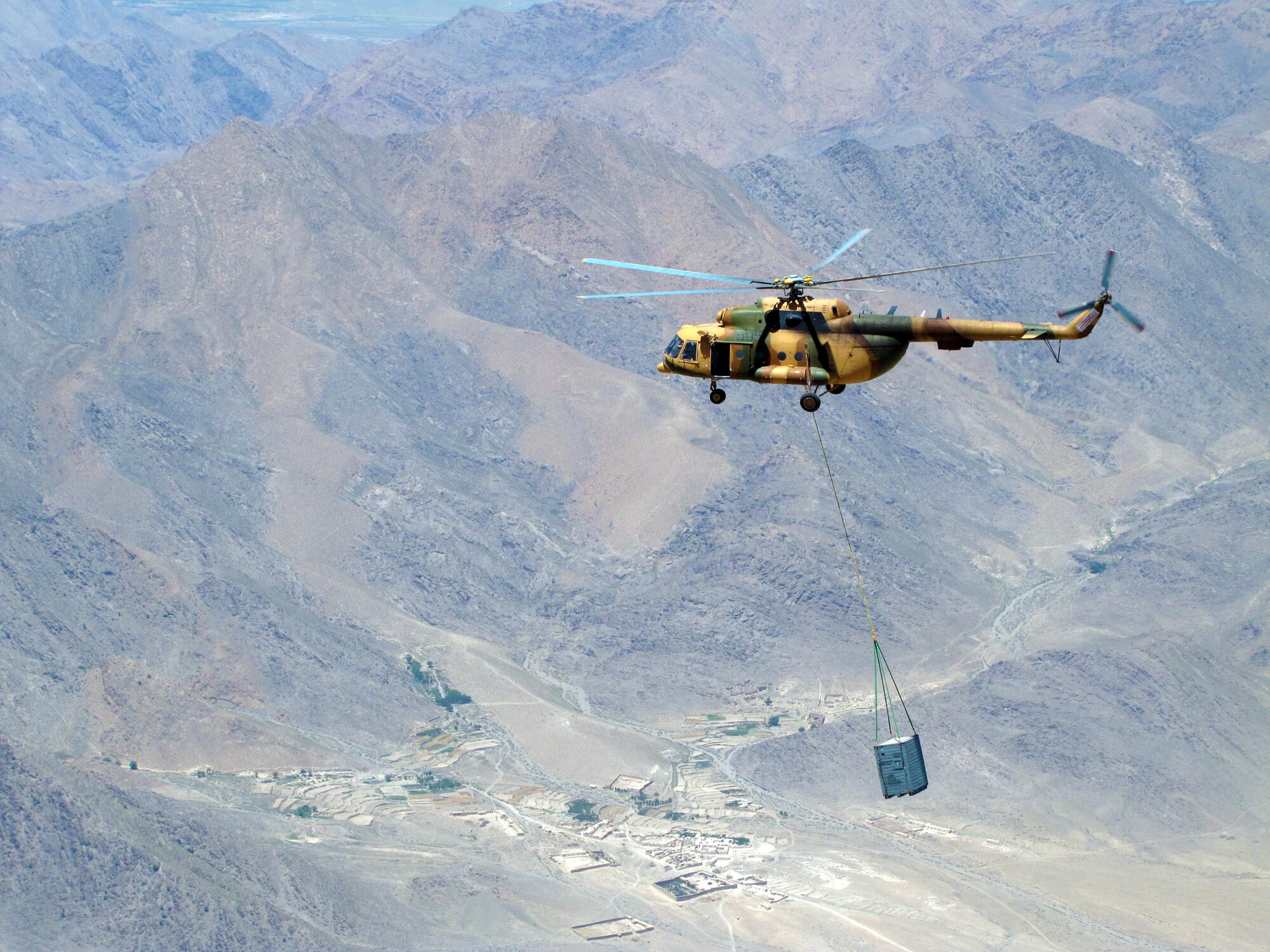 Afghan airmen and Combined Air Power Transition Force advisers conduct an operational sling load with the Mi-17 transport helicopter July 1, 2010 to Forward Operating Base Orgun-e, Afghanistan. (U.S. Air Force photo/Capt. Robert Leese)