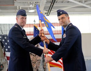 LANGLEY AIR FORCE BASE, Va. -- Col. Donald Kirkland (left), 633d Air Base Wing commander, presents the 633d Mission Support Group unit guidon to Col. Kenneth J. D’Alfonso, new 633d MSG commander, during the 633d MSG change of command ceremony July 1, at the 71st Fighter Squadron hangar. Colonel D'Alfonso, a graduate of the U.S. Air Force Academy, recently attended the Army War College. (U.S. Air Force photo/Senior Airman Dana Hill)
