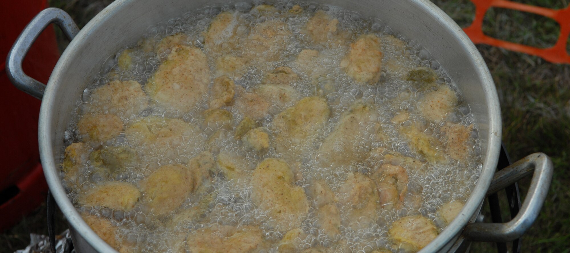 RAF Mildenhall, England – Fried Pickles, one of many unique foods sold at the 4th of July celebration at RAF Feltwell, boils in hot oil behind the 488th Intelligence Squadron tent.  The annual event celebrates American independence and Freedom.  (U.S. Air Force photo/Staff Sgt. Christopher L. Ingersoll)