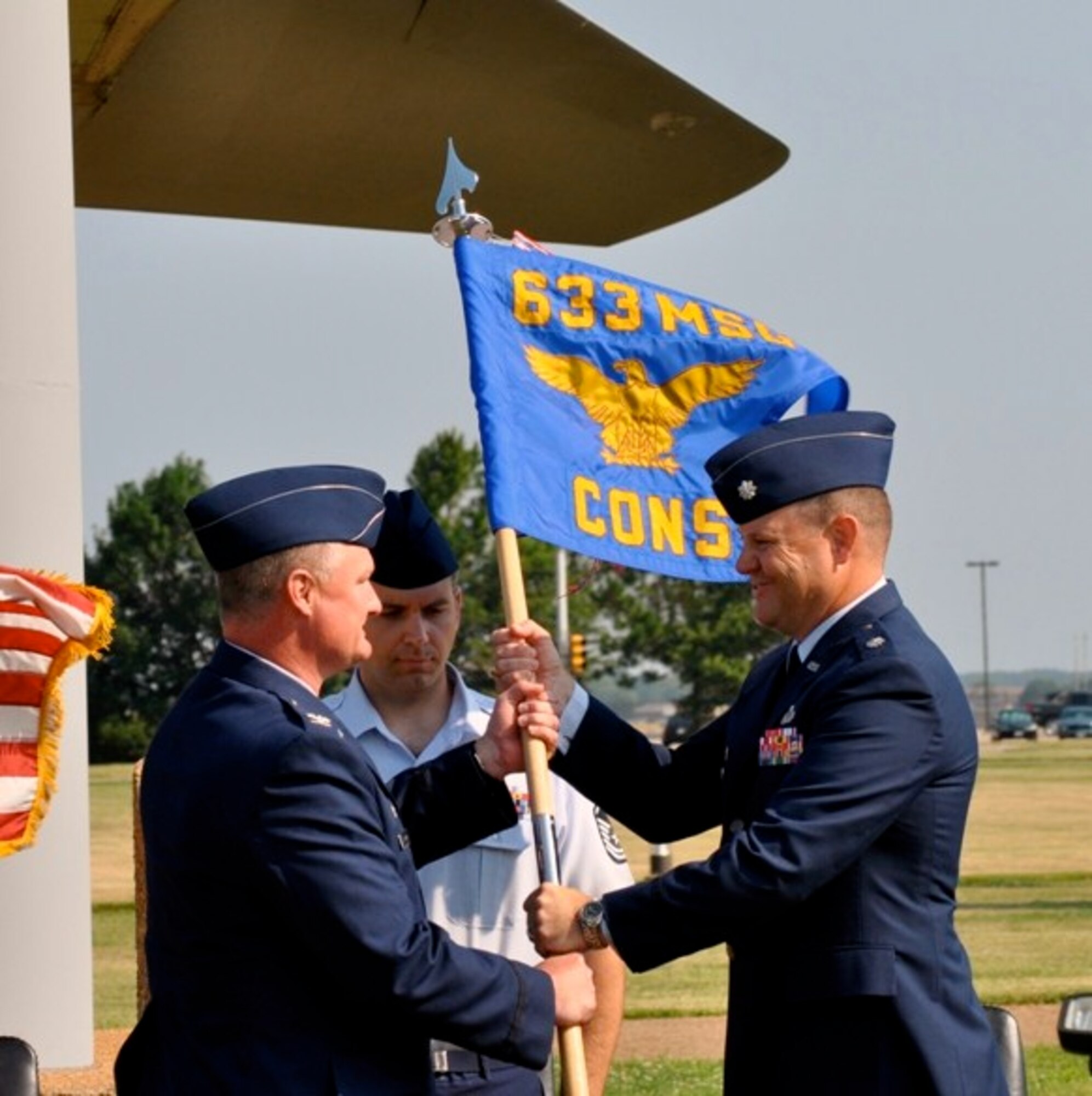 LANGLEY AIR FORCE BASE, Va. -- Col. Kevin Altman (left), then-633d Mission Support Group commander, presents the unit guidon to Lt. Col. Christopher Wegner at the 633d Contracting Squadron change of command ceremony at Air Power Park June 28. Colonel Wegner assumed command of the squadron from Lt. Col. Randy Rivera. (Courtesy photo)