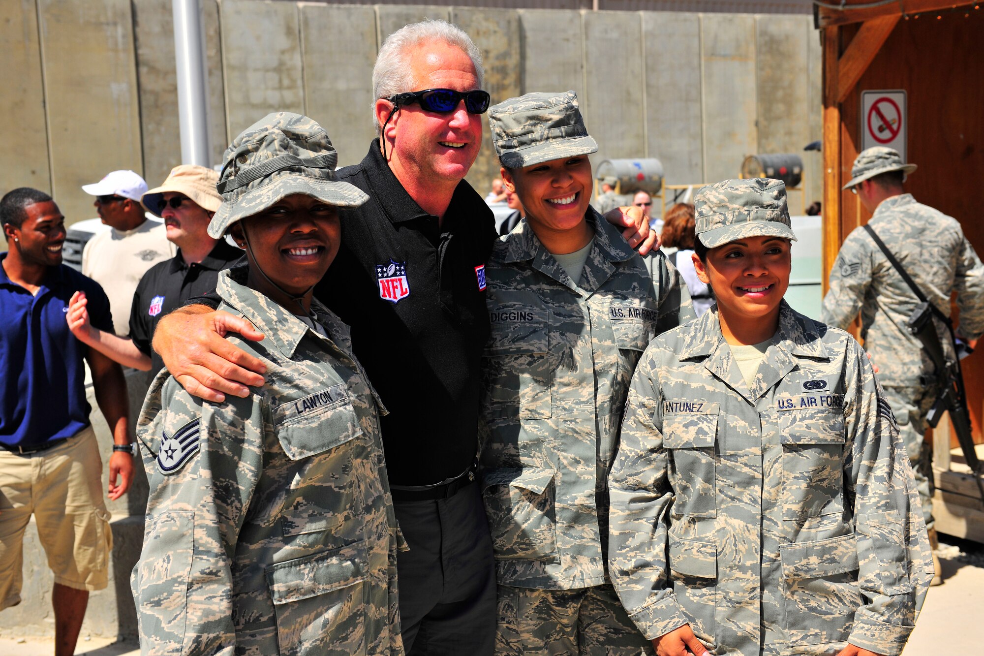 John Fox, head coach of the National Football League's Carolina Panthers, poses for pictures with Airmen during a USO visit at Bagram Airfield, Afghanistan, July 4, 2010. The visit included head coaches from the Cincinnati Bengals, Minnesota Vikings and the Philadelphia Eagles. (U.S. Air Force photo/Staff Sgt. Christopher Boitz)
