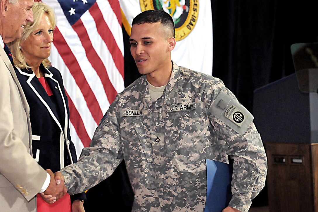U.S. Army Pfc. Ferney Bonilla shakes hands with Vice President Joe Biden shortly after becoming a U.S. citizen during a naturalization ceremony on Camp Victory in Baghdad,
July 4, 2010. Bonilla, assigned to the 82nd Airborne Division's 307th Brigade Support Battalion, 1st Advise and Assist Brigade, is originally from Colombia.