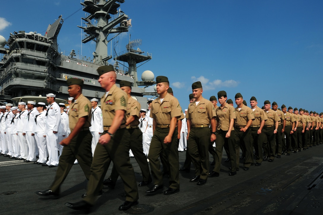 U.S. Marines assigned to Marine Fighter Attack Squadron 323 march in ...