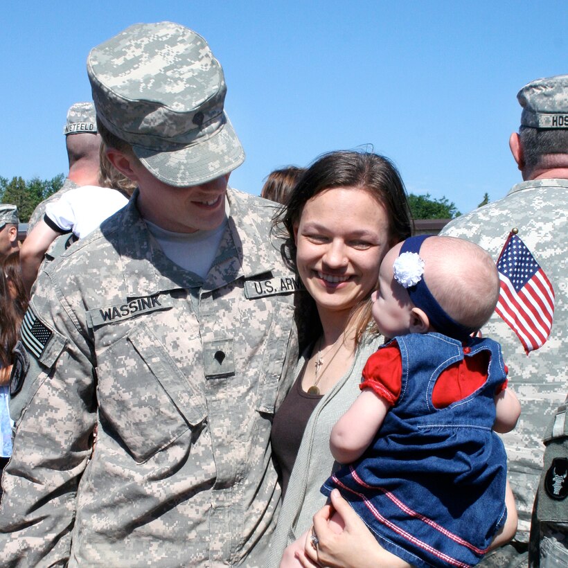 U.S. Army Spc. Nathaniel Wassink, left, hugs his family after a nine-month deployment to Basrah, Iraq, to support Operation Iraqi Freedom at the armory in Cottage Grove, Minn., July 1, 2010. Wassink is assigned to the 204th Area Support Medical Company. 
