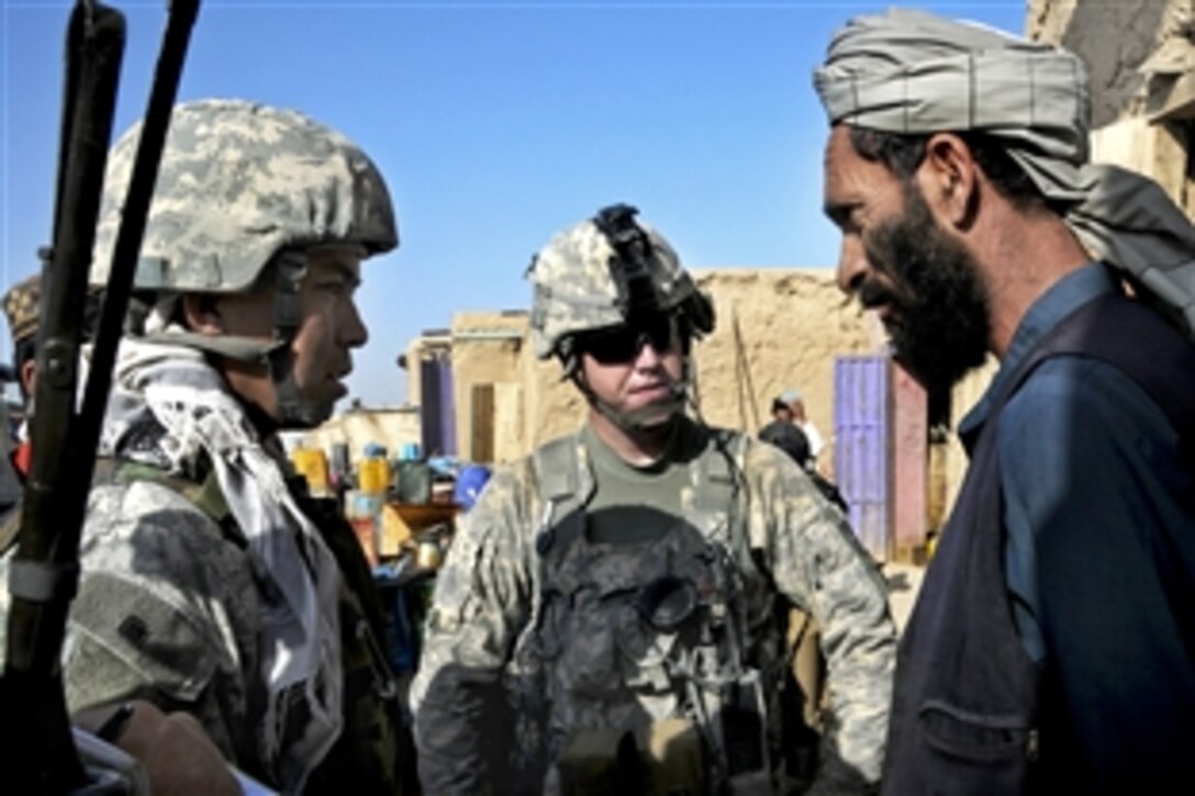 U.S. Army 1st Lt. Matthew Hilderbrand, center, and an Afghan interpreter talk with an Afghan man during a patrol at a bazaar near Combat Outpost Sangar in Zabul province, Afghanistan, July 3, 2010. Hilderbrand is assigned to Company D, 1st Battalion, 4th Infantry Regiment.