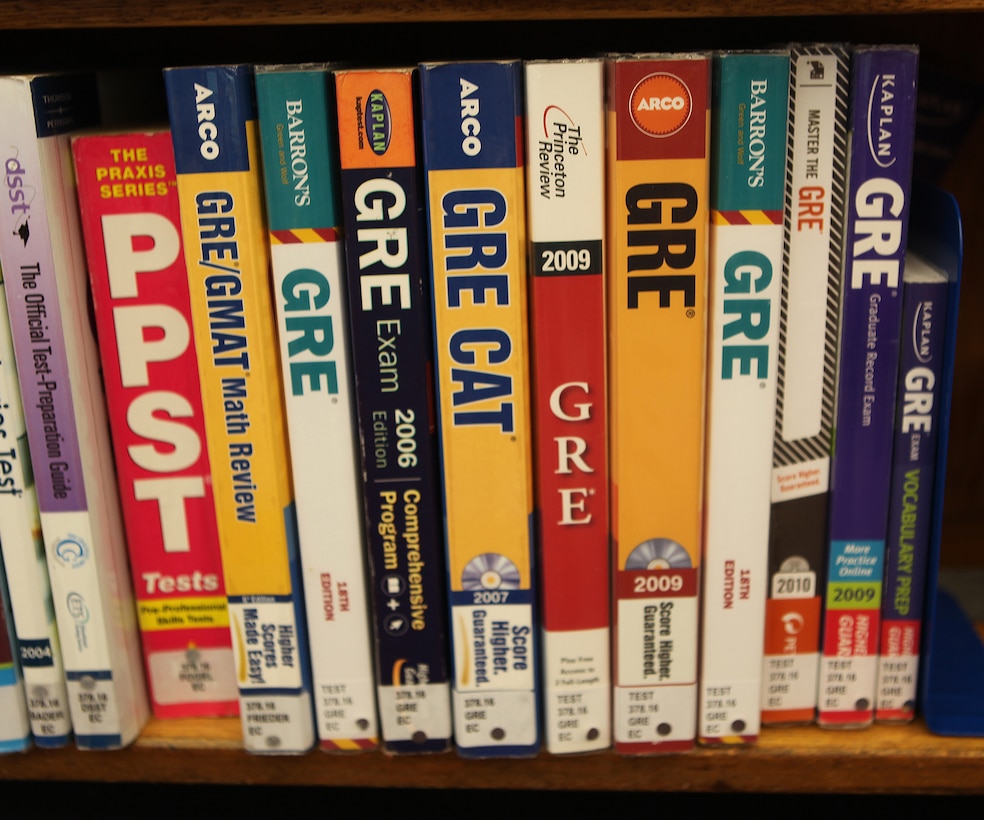 Graduate Record Exam test booklets sit on a bookshelf at the resource library in the Base Education Center aboard Marine Corps Base Camp Lejeune.  The GRE is a type of admissions test some graduate schools may require service members, families, Department of Defense civilians and retired military members to take before pursuing a post-baccalaureate education.