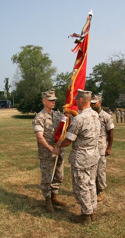 Colonel Frank Kelley (left) receives the Command Colors from Brigadier General Michael Brogan signifying the change of command at Marine Corps Systems Command