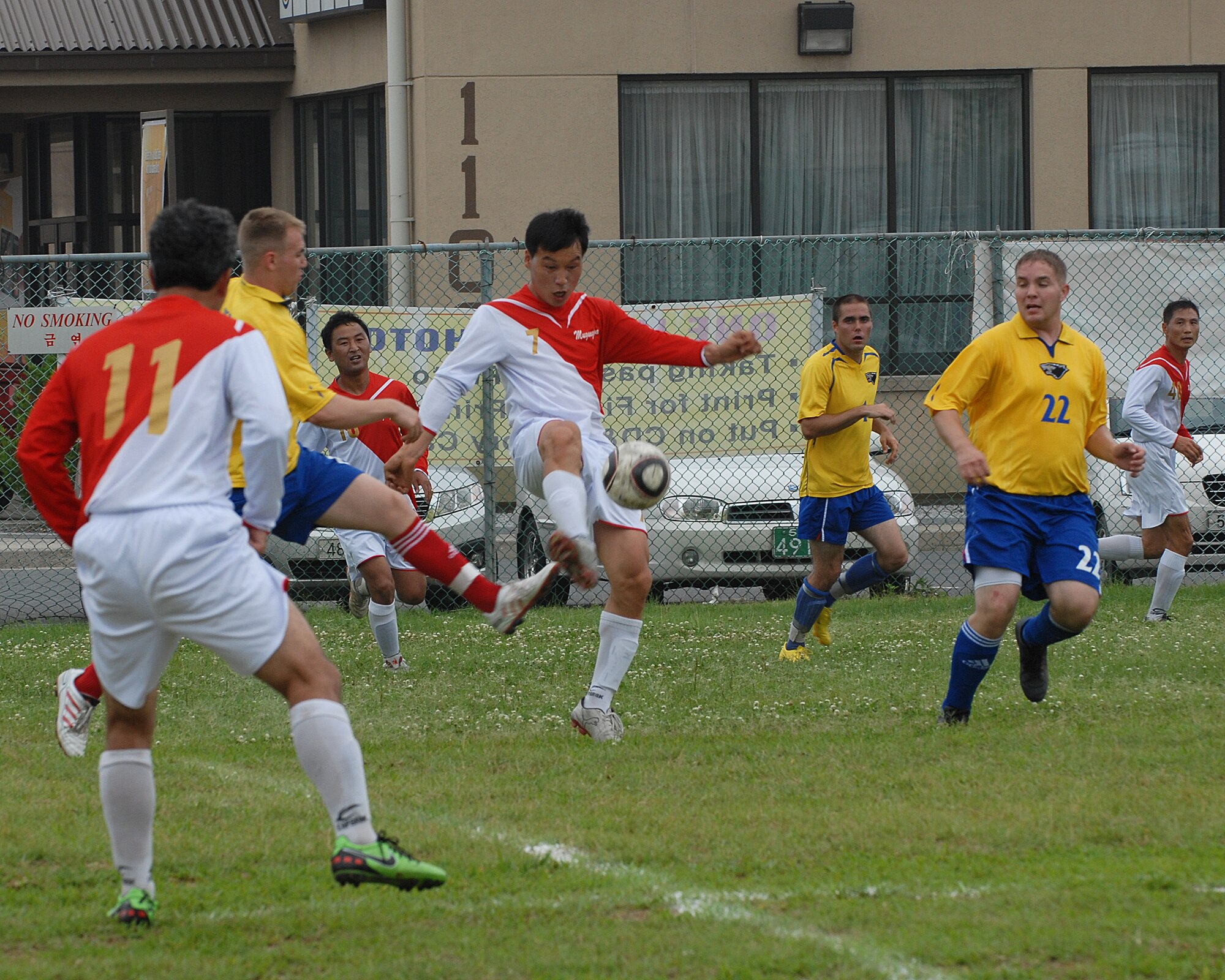 KUNSAN AIR BASE, Republic of Korea -- Corporal Chang Sun-ok from the Korean National Police kicks a soccer ball here July 4. The Kunsan Soccer Team played the Korean National Police during the Independence Day festivities. In addition to the soccer game, there was also a five kilometer run, cardboard boat race, a free barbecue and more, culminating in a fireworks show at the end of the night.(U.S. Air Force photo/Senior Airman Roy Lynch)