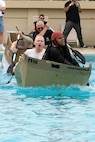 KUNSAN AIR BASE, Republic of Korea --   2nd Lt. Tabish Khan and 1st Lt. Dan Winn, both of the 8th Operations Group, struggle to stay ahead of another team during the cardboard boat race July 4 at the base pool. In addition to the boat race, there was also a five kilometer run, firefighter relay race, a free barbecue and more, culminating in a fireworks show at the end of the night. (U.S. Air Force photo/Staff Sgt. Jonathan Pomeroy)