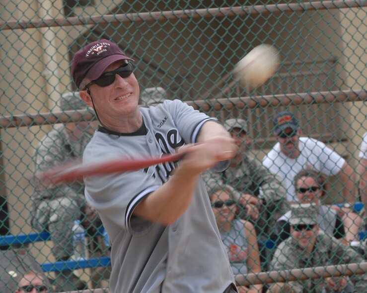 KUNSAN AIR BASE, Republic of Korea -- Col. John Dolan, 8th Fighter Wing commander, hits a softball during a Chief and Eagles softball game here July 4. Colonel Dolan along with other Wolf Pack members celebrated Independence Day with such events as a firefighter relay race, five kilometer run, cardboard boat race, a free barbecue and more, culminating in a fireworks show at the end of the night. (U.S. Air Force photo/Senior Airman Roy Lynch)