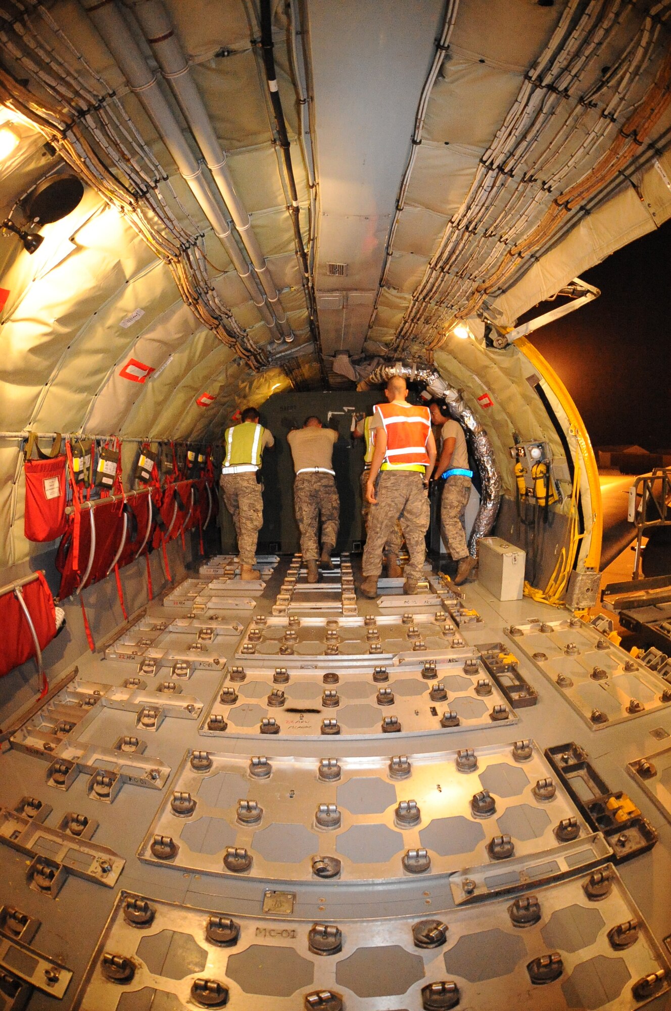 Team McConnell Airmen load a KC-135 Stratotanker during a global response exercise June 24, 2010, McConnell Air Force Base, Kan. The exercise was a U.S. Strategic Command-led exercise performed along with other Air Mobility Command bases. During the exercise, McConnell processed 94 personnel, generated four KC-135 Stratotankers with four more tankers supporting the exercise and processing 13.5 short tons of cargo. (U.S. Air Force photo/Tech. Sgt. Chyrece Campbell)