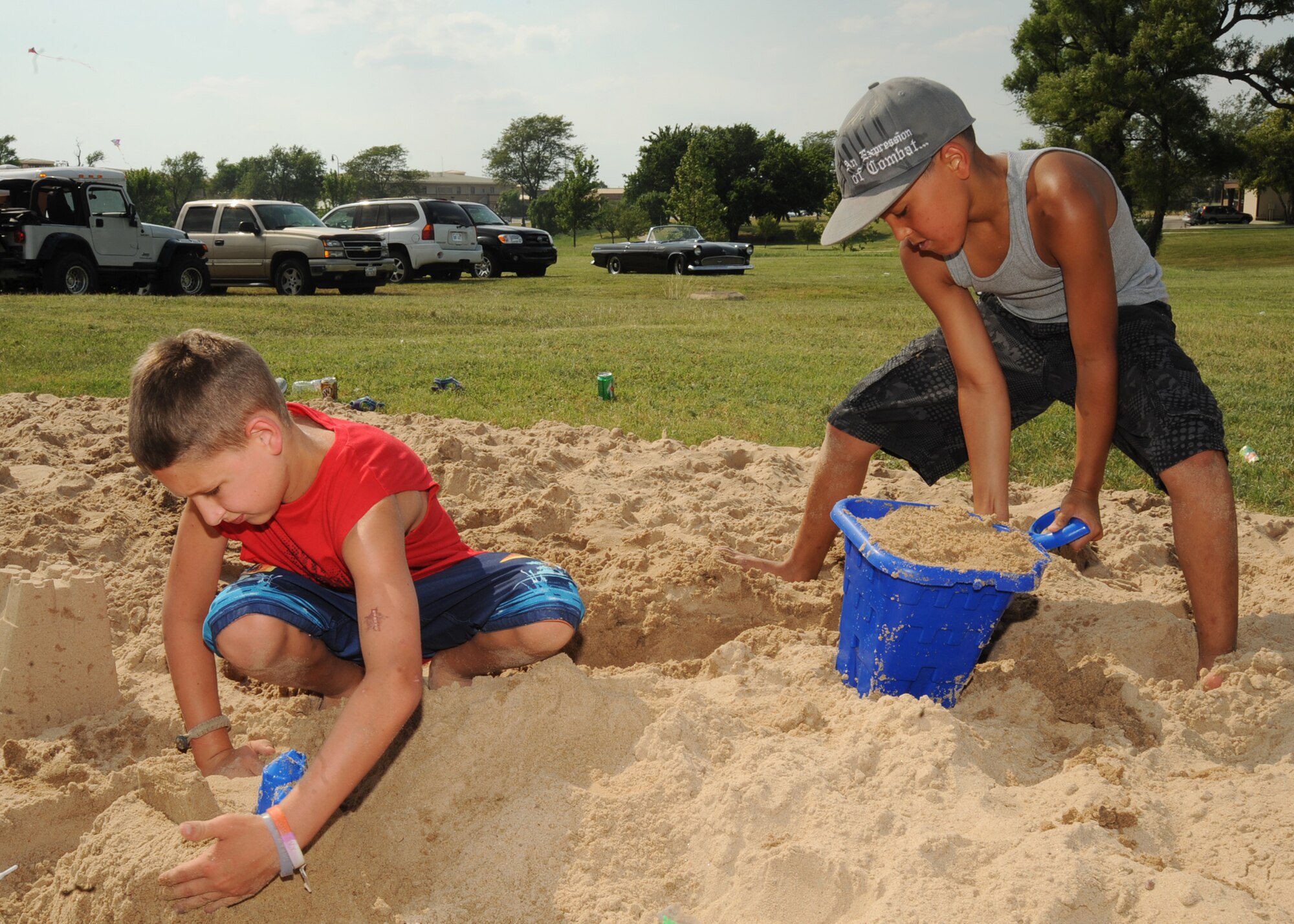 Mason Carr, 9, and Connor Ireland, 10, compete in a sand castle contest during a beach party July 1, 2010, McConnell Air Force Base, Kan.  The party included treasure hunts, sidewalk chalk art and canoe races for Team McConnell members and their families.  The festivities gave Team McConnell members an opportunity to relax with family members before the Fourth of July weekend.  More than 850 Team McConnell members attended the event.  (U.S. Air Force photo/ Senior Airman Maria Ruiz)