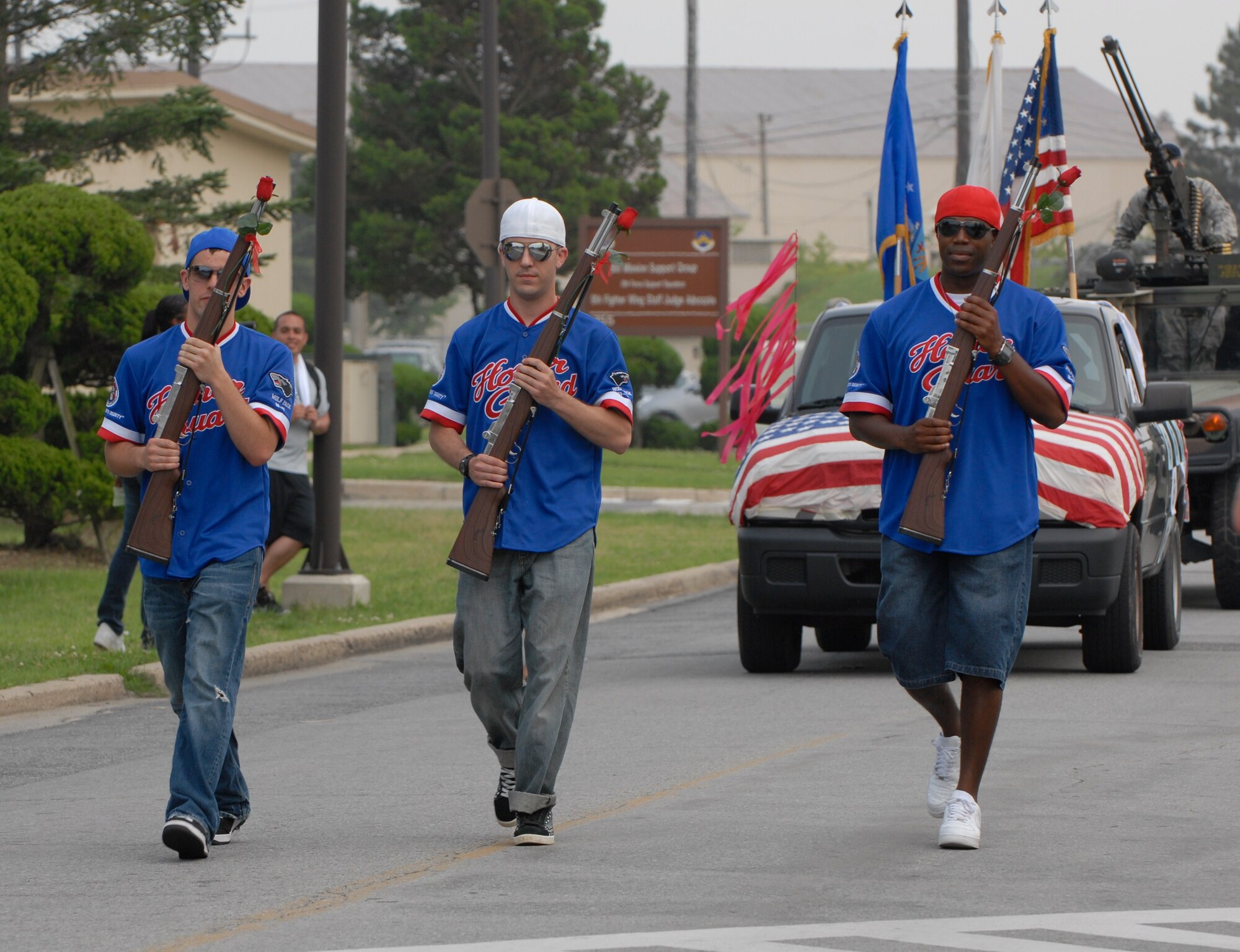KUNSAN AIR BASE, Republic of Korea -- Airman 1st Class Robert Goodno, Airman 1st Class Jason Miller and Staff Sgt. Kevin Tatum, Kunsan Honor Guard members, march during a parade here July 4. In addition to the parade, there was also a five kilometer run, cardboard boat race, a free barbecue and more, culminating in a fireworks show at the end of the night. (U.S. Air Force photo/Staff Sgt. Amanda Savannah)