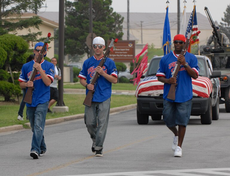 KUNSAN AIR BASE, Republic of Korea -- Airman 1st Class Robert Goodno, Airman 1st Class Jason Miller and Staff Sgt. Kevin Tatum, Kunsan Honor Guard members, march during a parade here July 4. In addition to the parade, there was also a five kilometer run, cardboard boat race, a free barbecue and more, culminating in a fireworks show at the end of the night. (U.S. Air Force photo/Staff Sgt. Amanda Savannah)