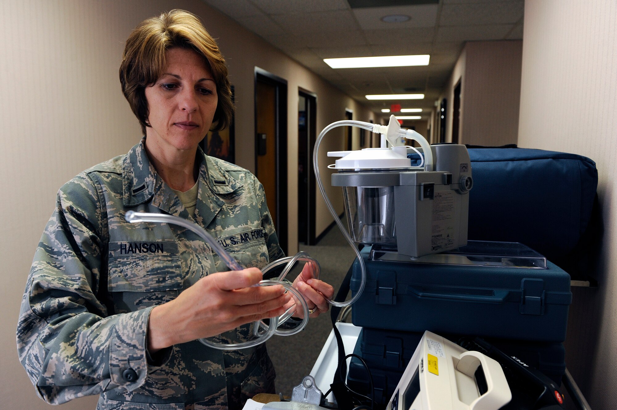 ELLSWORTH AIR FORCE BASE S.D.-1st Lt. Shelly Hanson, 28th Medical Operations Squadron nurse case manager, conducts an inspection of an oral-suction catheter, July 6.  The catheter is used to remove phlegm, vomit, saliva or any other fluid from a patient’s airway or stomach. (U.S. Air Force photo/Staff Sgt. Marc I. Lane)