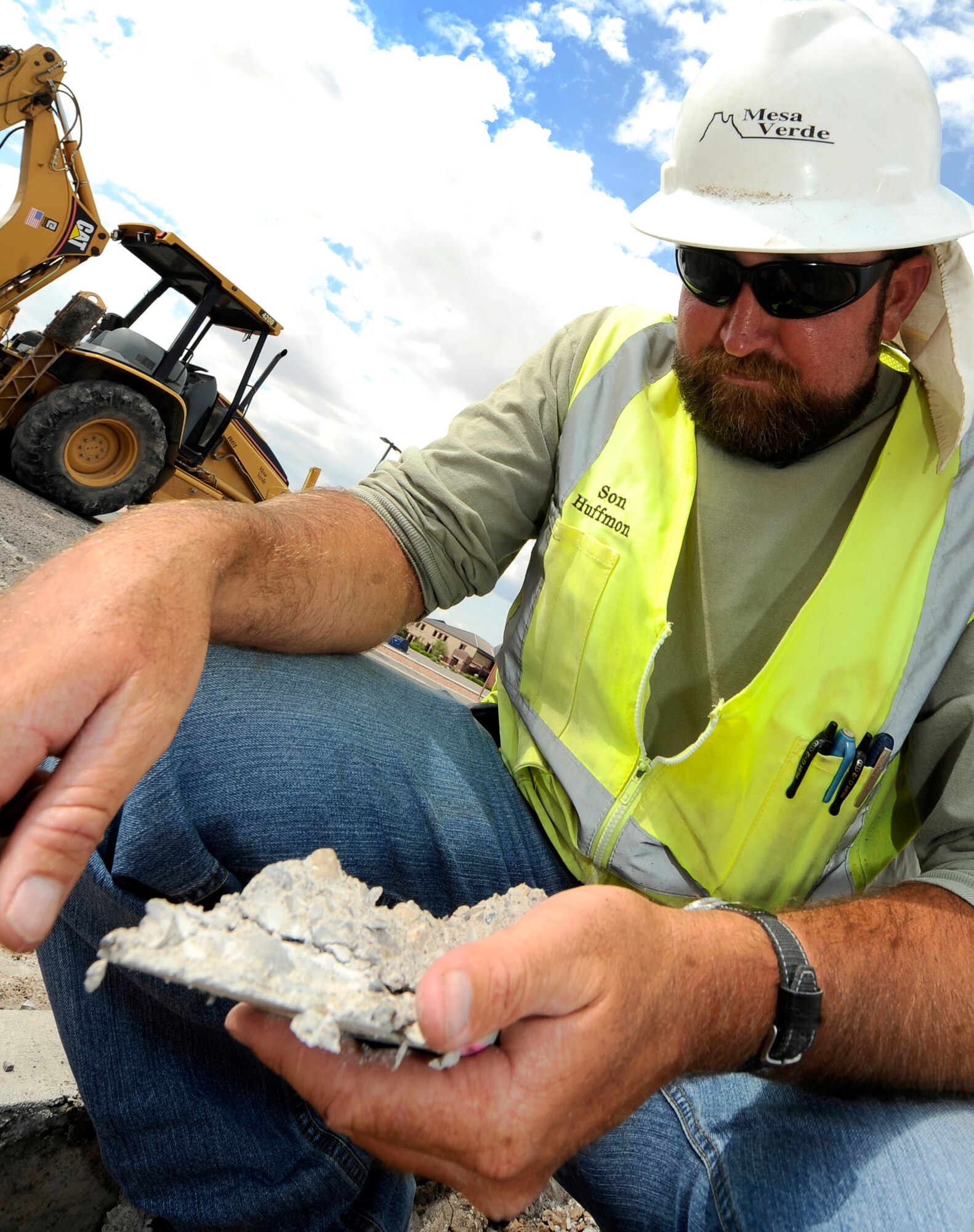 HOLLOMAN AIR FORCE BASE, N.M. -- Son Huffmon, a superintendant from the Mesa Verde Enterprises Inc., inspects the fiber reinforced concrete after breaking down New Mexico Avenue with a jackhammer near the Base Commissary June 29, 2010. The road construction project originally started by renovating Bong Street and Sabre Road. New Mexico Avenue will be under construction for the next five months in an effort to improve the infrastructure at Holloman. (U.S. Air Force photo by Senior Airman Veronica Stamps / Released)