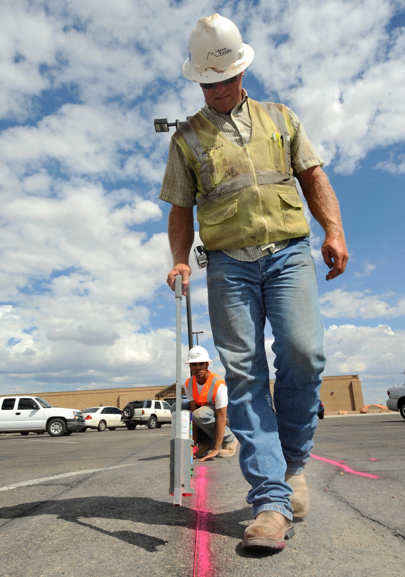 HOLLOMAN AIR FORCE BASE, N.M. -- Eric McFarland, a foreman with the Mesa Verde Enterprises Inc., uses a tag stick to mark lines for the construction of a new curb near the Base Commissary June 29, 2010. Before adding a new curbside, a bullnose is drawn to create a concrete bedded edge. Mesa Verde Enterprises Inc. employees will be working on New Mexico Avenue for the next five months in an effort to improve the infrastructure at Holloman. (U.S. Air Force photo by Senior Airman Veronica Stamps / Released)