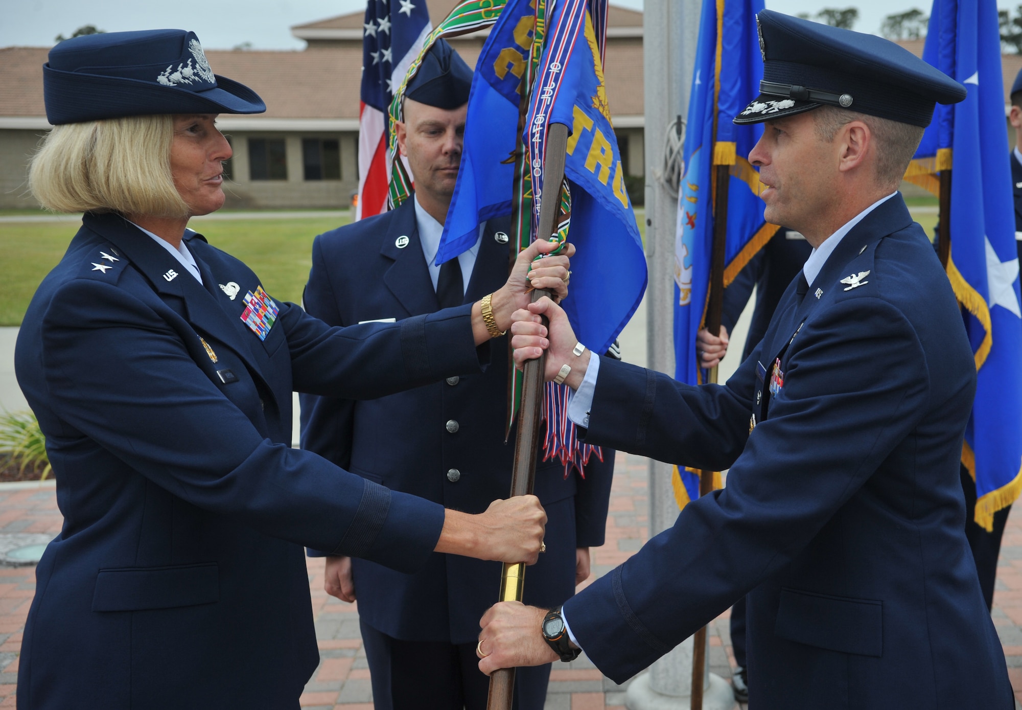 VANDENBERG AIR FORCE BASE, Calif. -- Col. Michael Lutton, the incoming 381st Training Group commander, assumes command as he accepts the guidon flag from Maj. Gen. Mary Kay Hertog, the 2nd Air Force commander, during the change of command ceremony here Wednesday, July 7, 2010.  (U.S. Air Force photo/Senior Airman Andrew Lee)