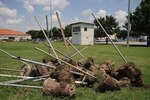 Fence posts lay askew July 7 as the base prepares to install a quarter-mile running track on Grater Field. (U.S. Air Force photo/Steve Thurow)